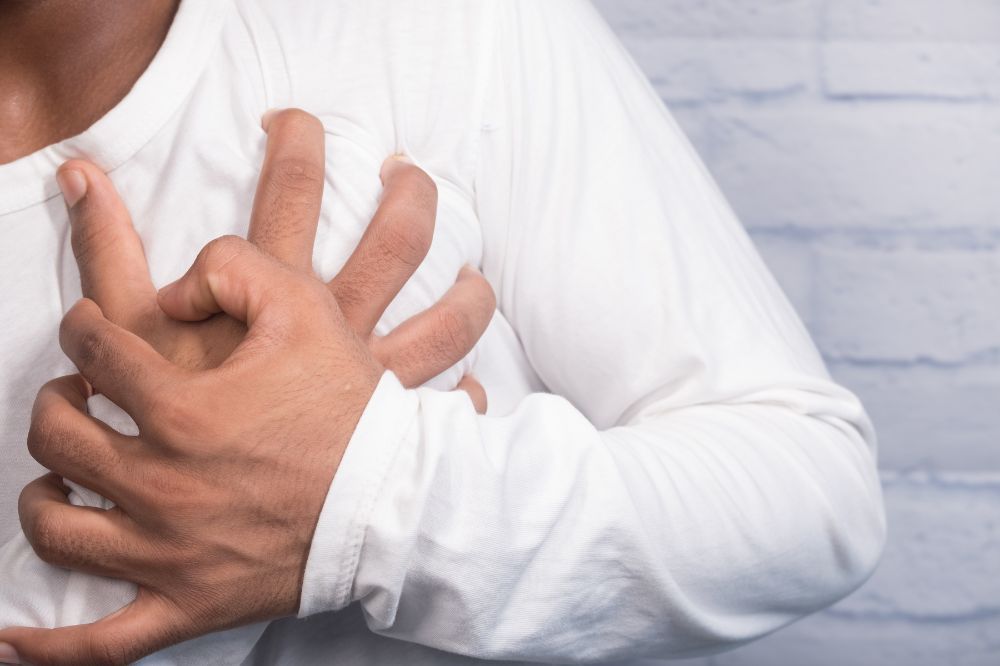 man clutching his chest in pain